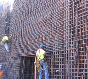 Self-consolidating concrete was chosen  as the best application for a tall wall pour with steel plates for link beams. 